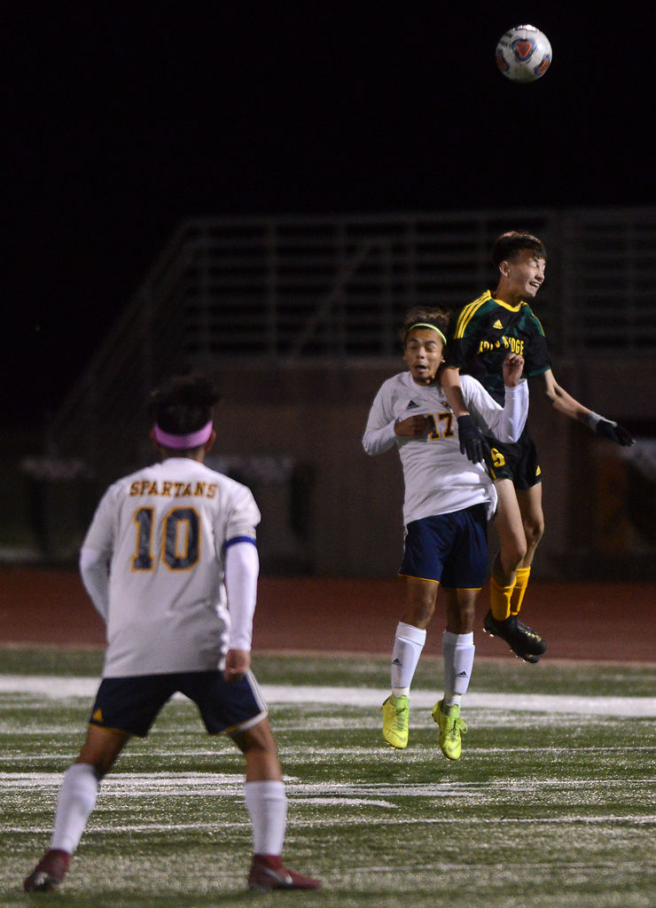 Ismail Senga and Tristan Greenplate fight for a header